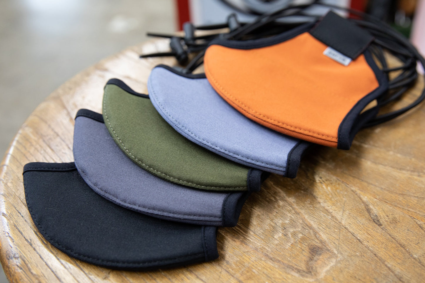 flat shot of the organic summer cotton masks in black, dark grey, olive, cool river, and burnt orange