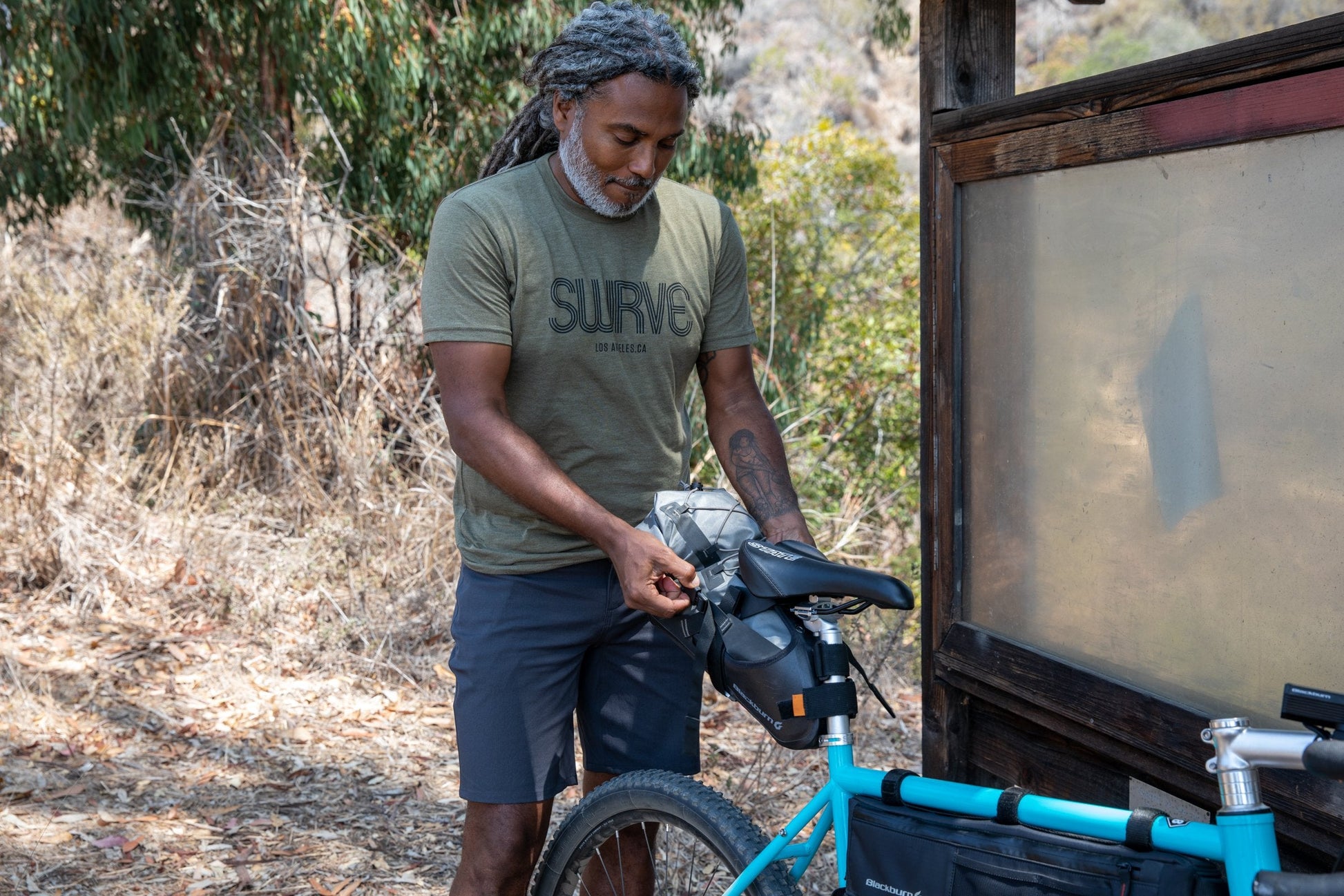 Erick in USA super soft tri-blend 1968 swrve logo t-shirt in heather pine.