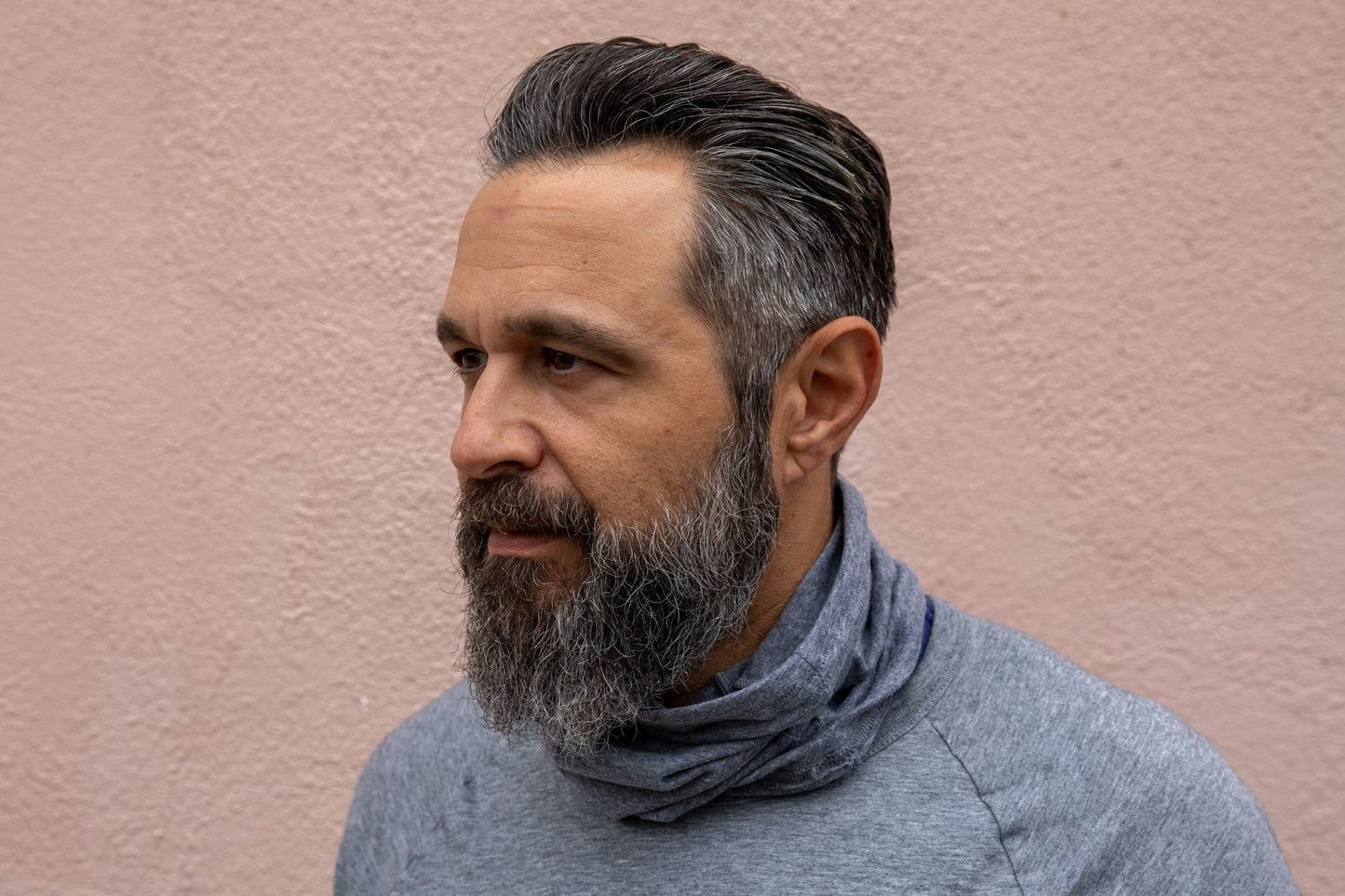a model wearing the heather grey neck gaiter