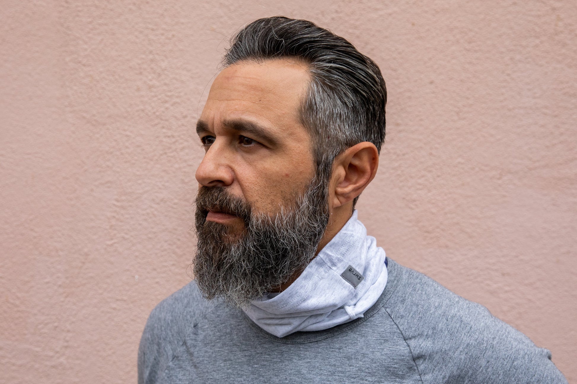 a model wearing the heather white neck gaiter