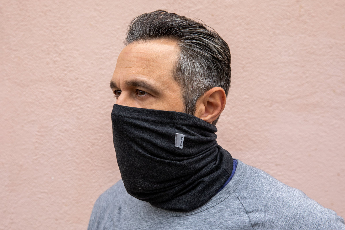 a model wearing the heather black neck gaiter