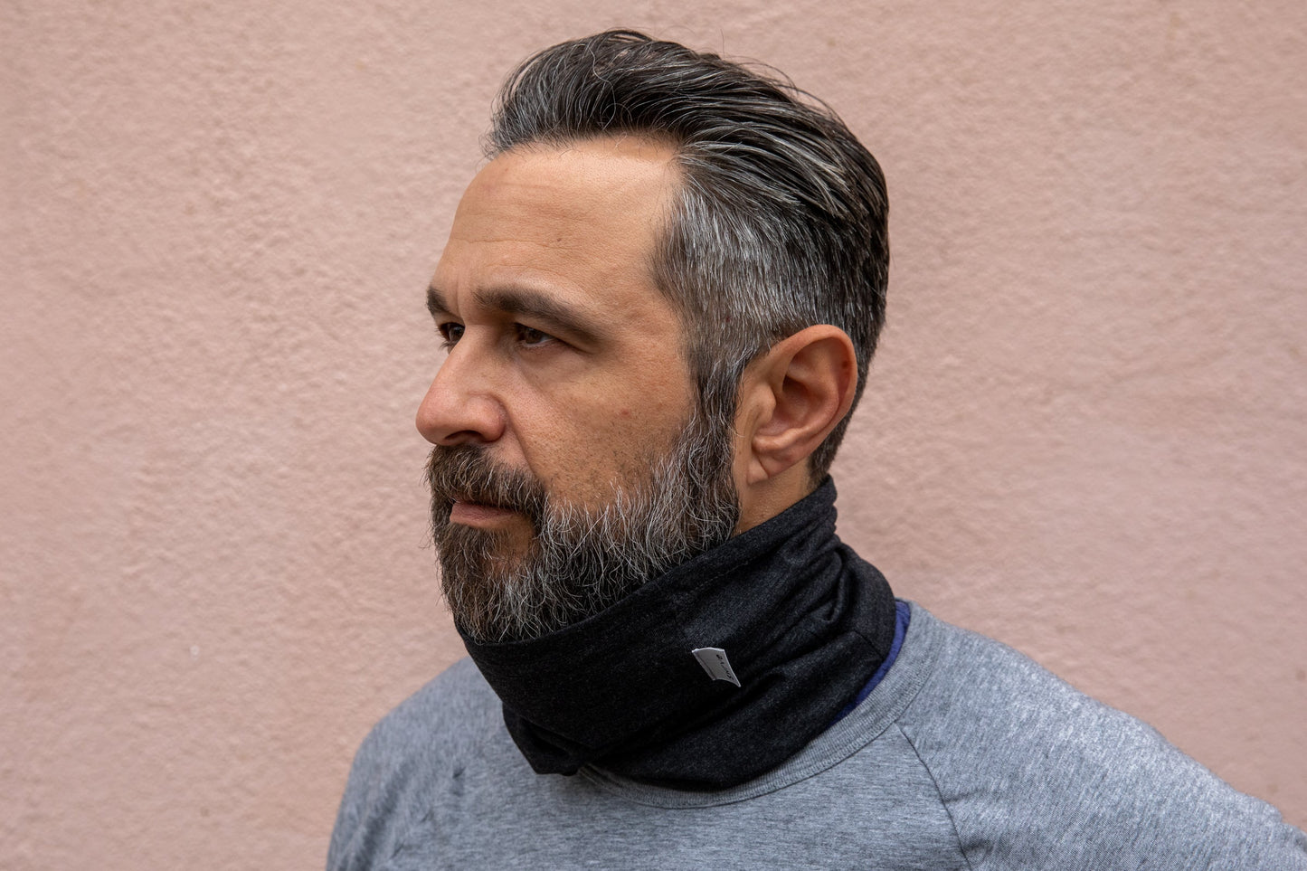 a model wearing the heather black neck gaiter