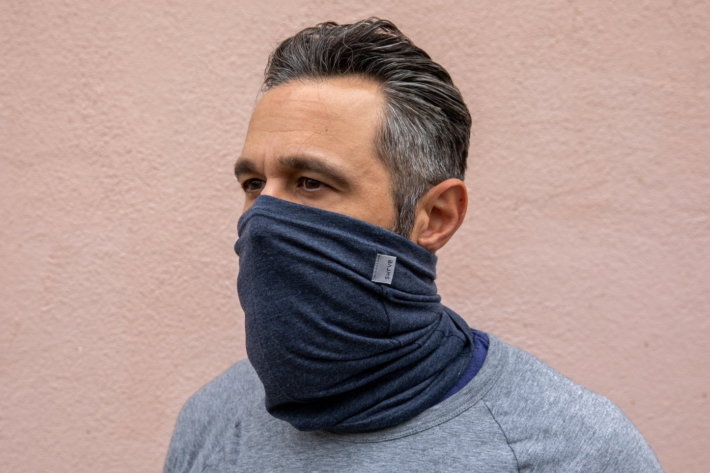 a model wearing the heather navy neck gaiter