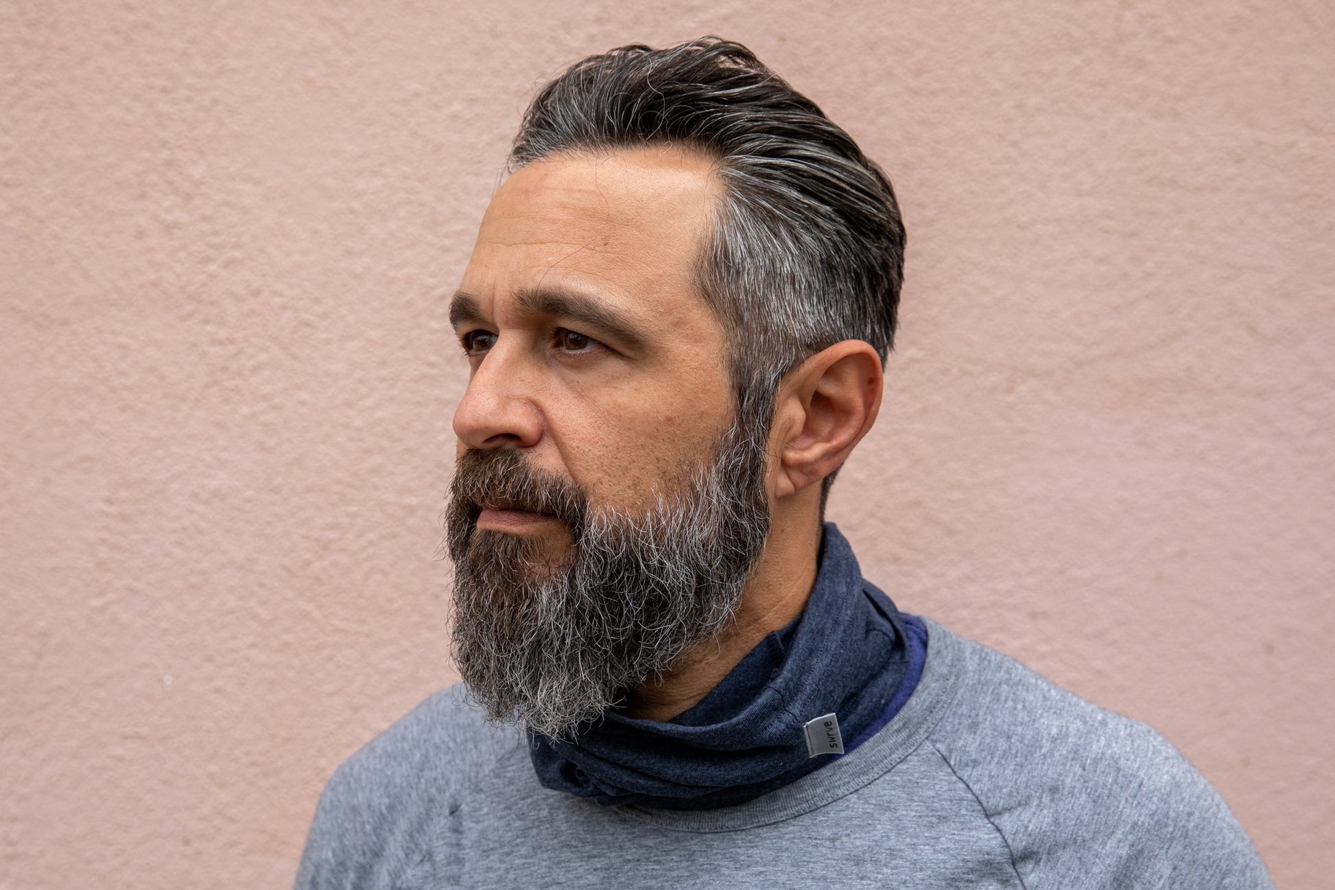 a model wearing the heather navy neck gaiter