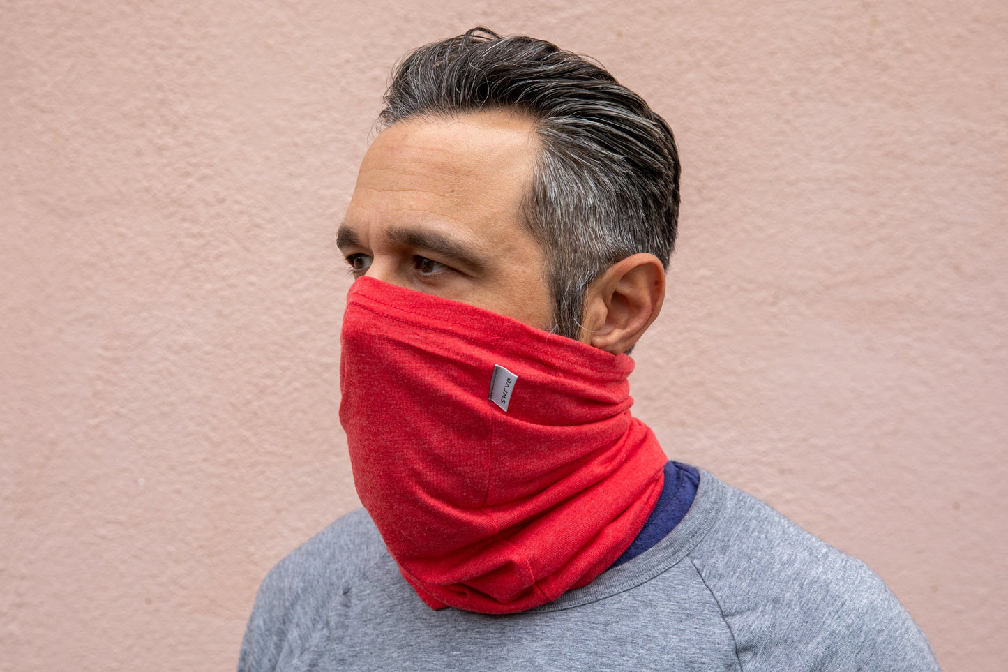 a model wearing the heather red neck gaiter
