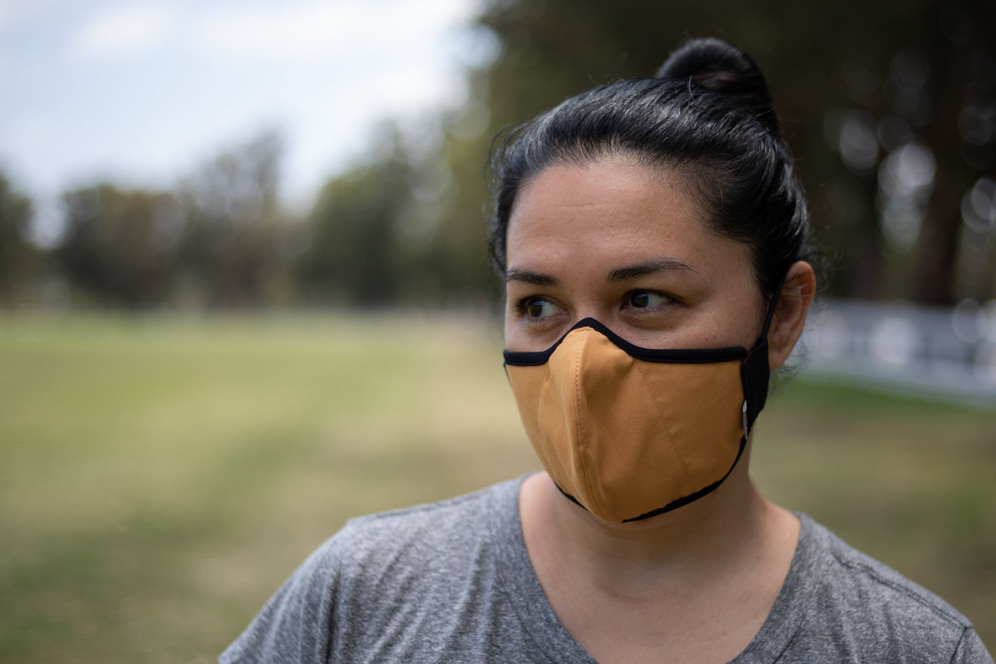 Sarah is wearing the mid-summer cotton mask in golden hour