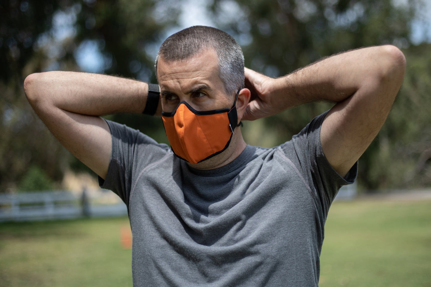 Josh is wearing the mid-summer cotton mask in sunset orange