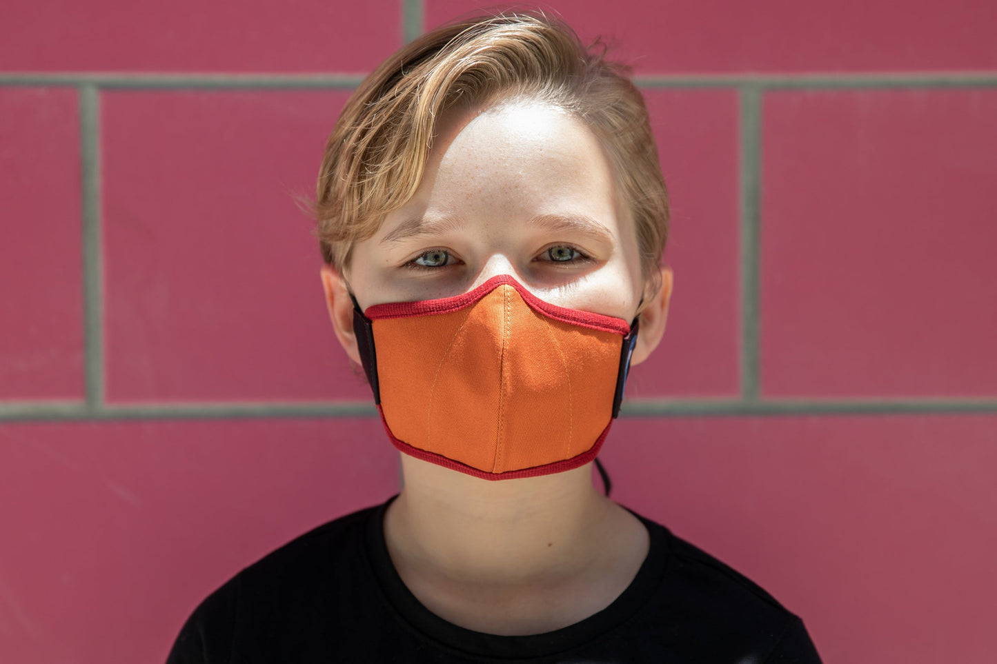 model wearing abby's kids summer cotton mask in leaf pile