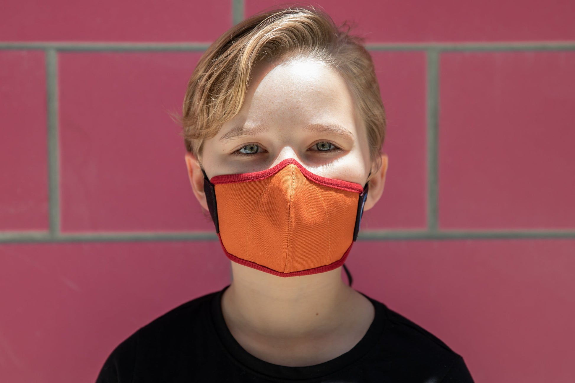 model wearing abby's kids summer cotton mask in leaf pile