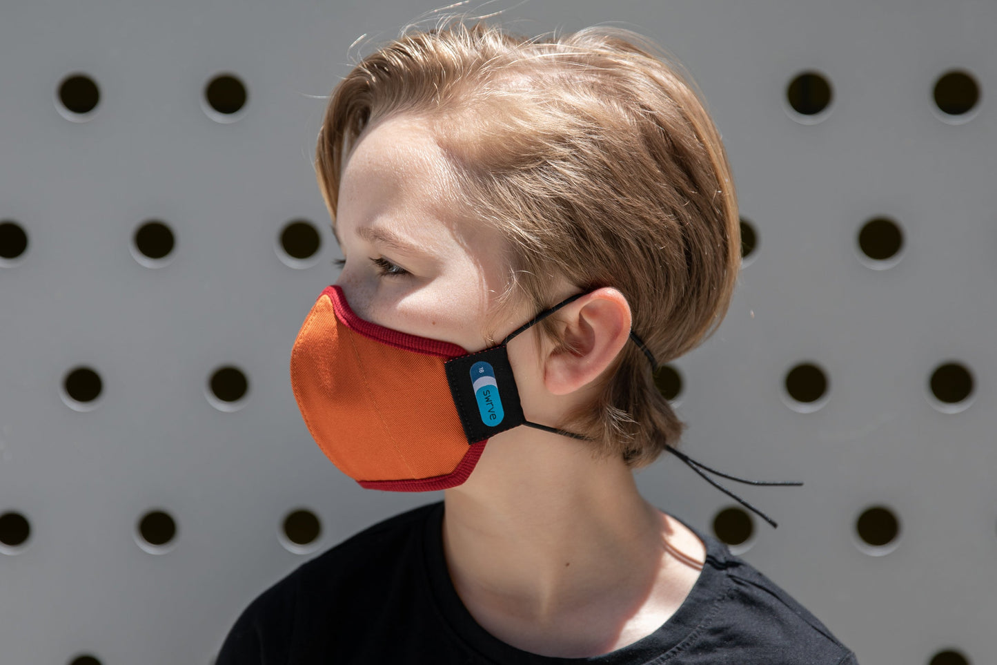 model wearing abby's kids summer cotton mask in leaf pile