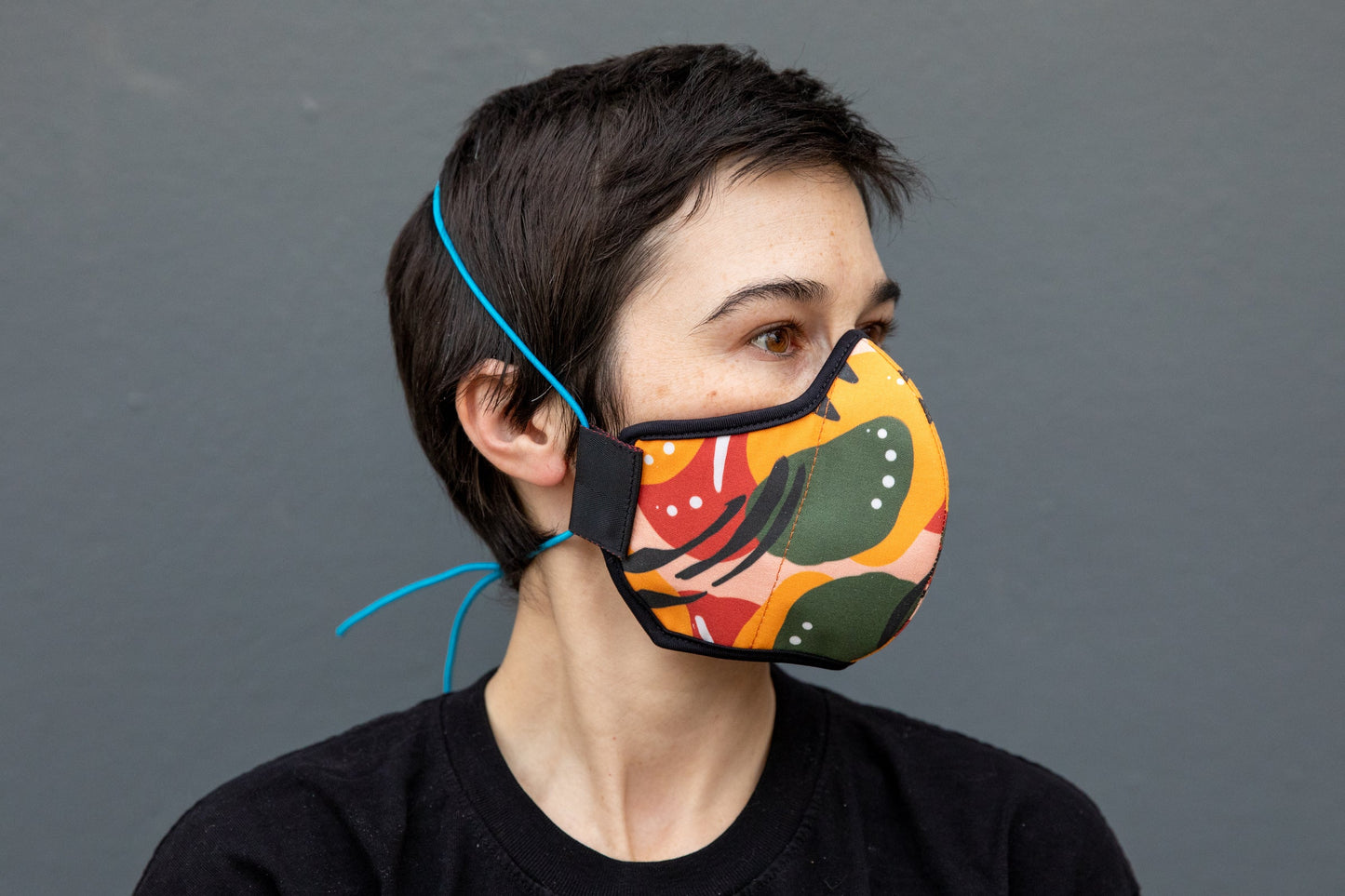 Roxy wearing the African cotton mask in mango chili in the adult fit