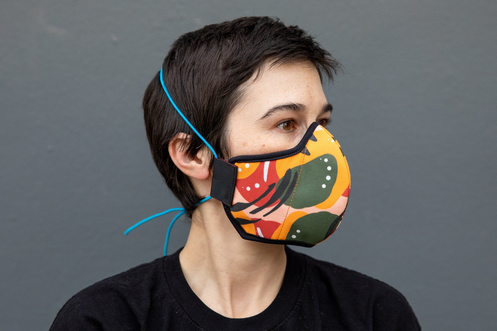 Roxy wearing the African cotton mask in mango chili in the adult fit