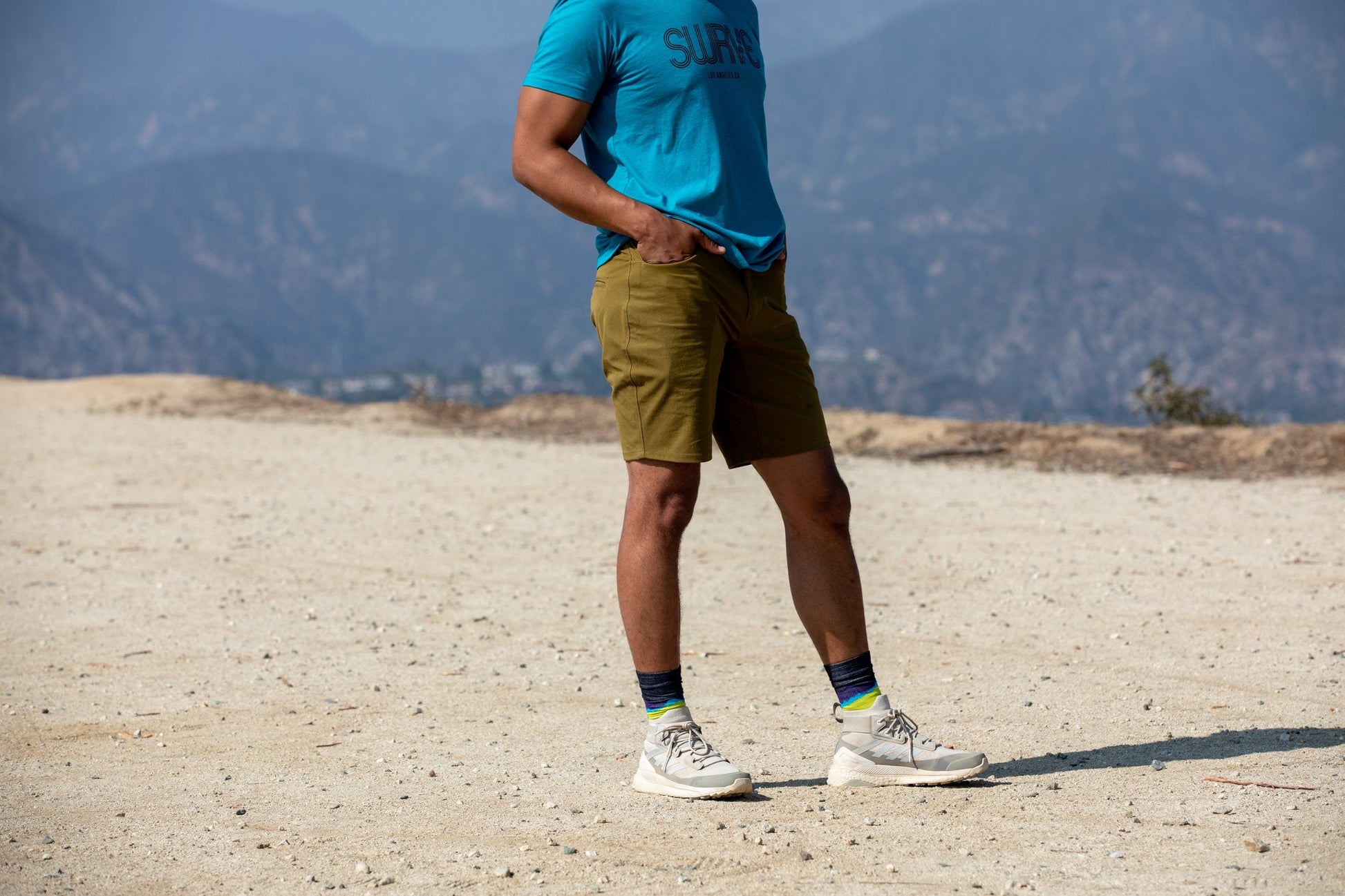 A model in a classic cotton/poly 1968 swrve logo t-shirt in cyan.
