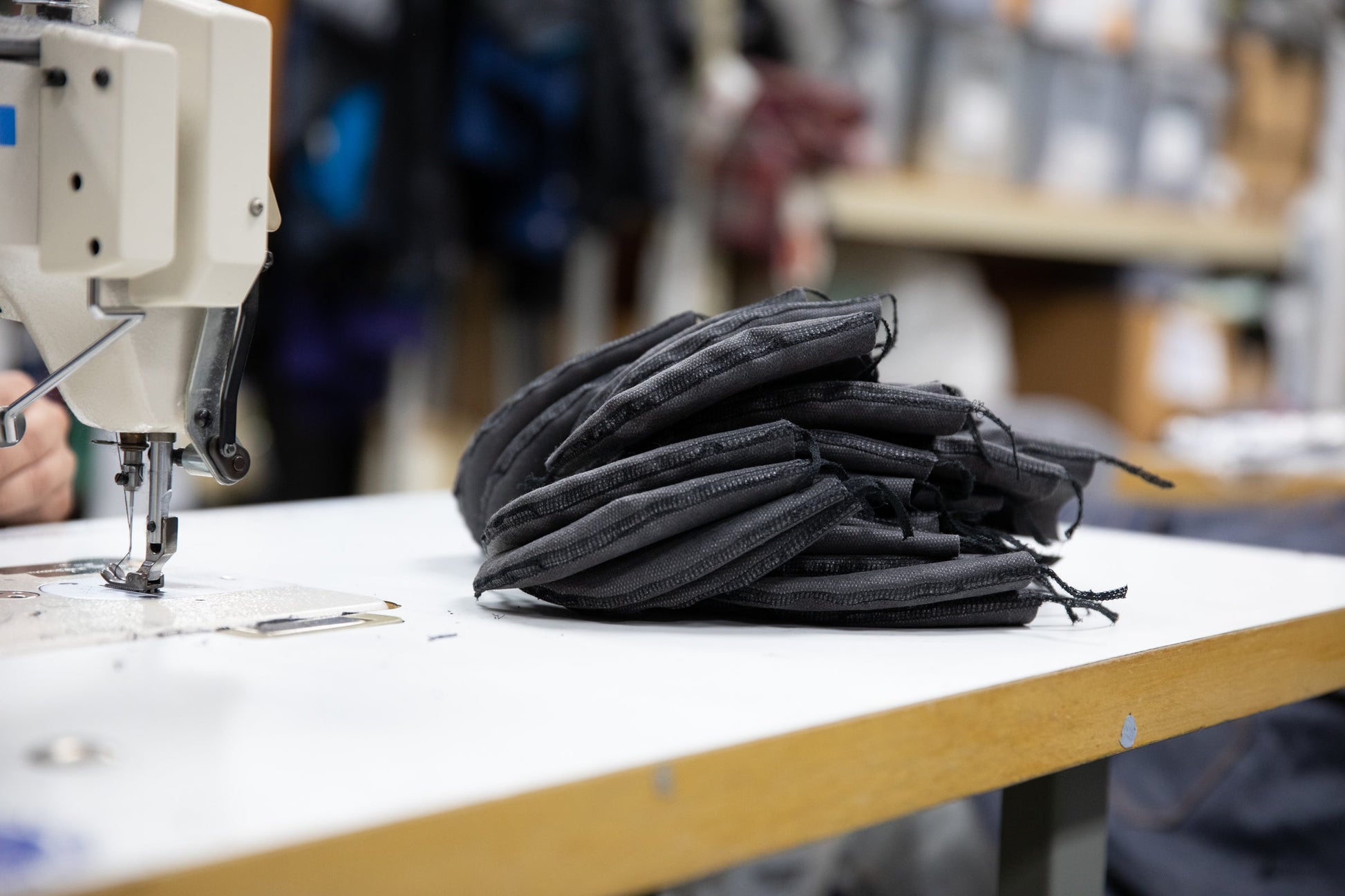 queue of grey masks in the sewing room waiting to be sewn