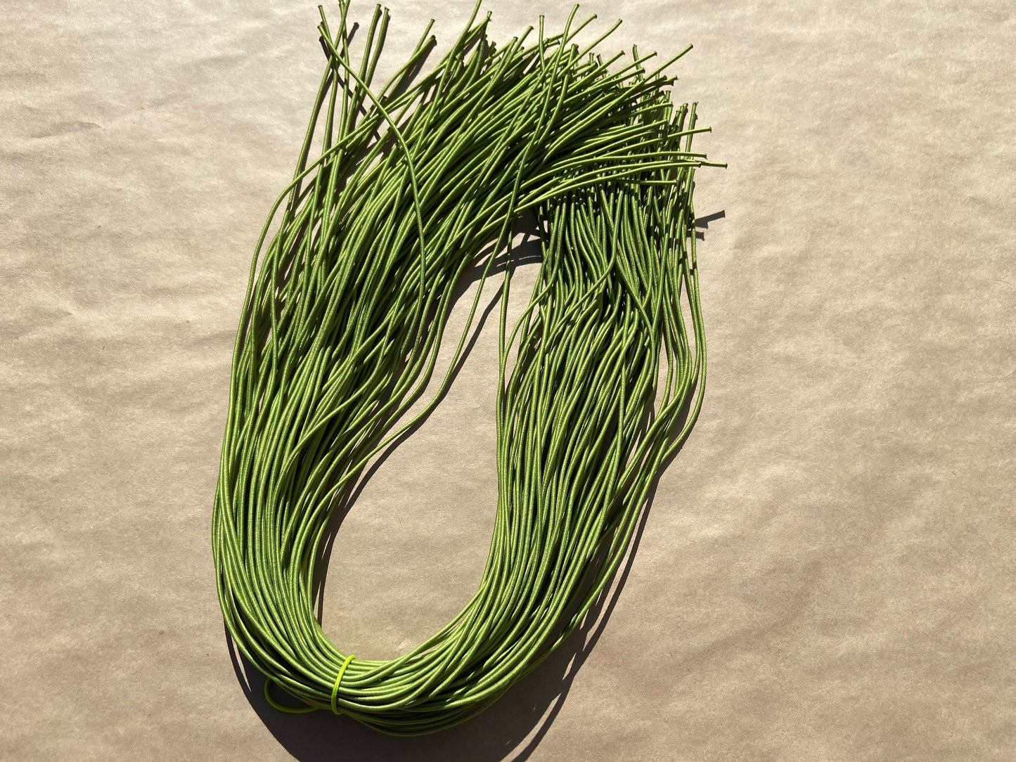 flat shot of our mask color cord in sage