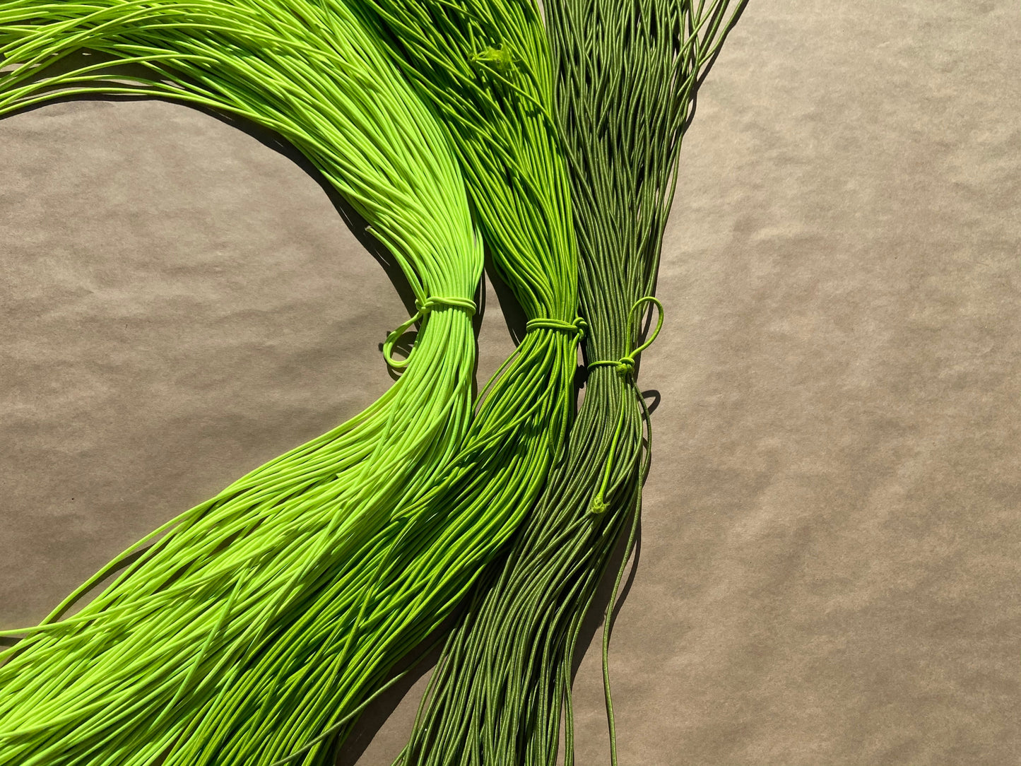 flat shot of our mask color cords in highlighter, lime, and sage