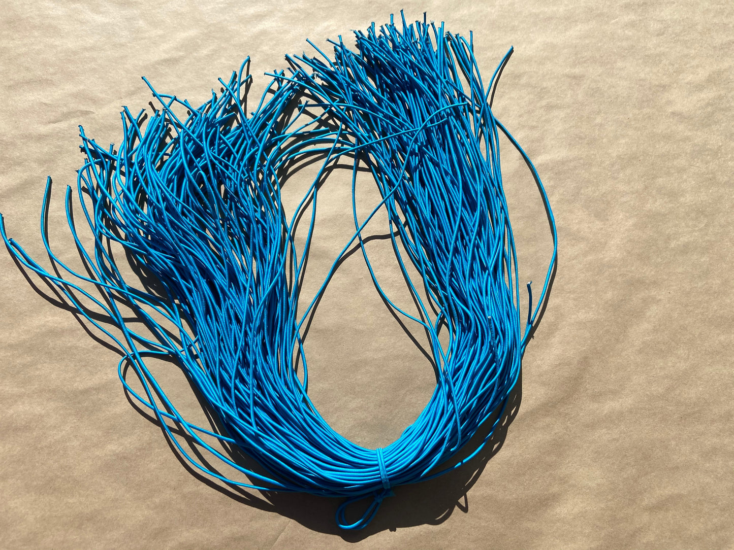 flat shot of our mask color cord in cyan