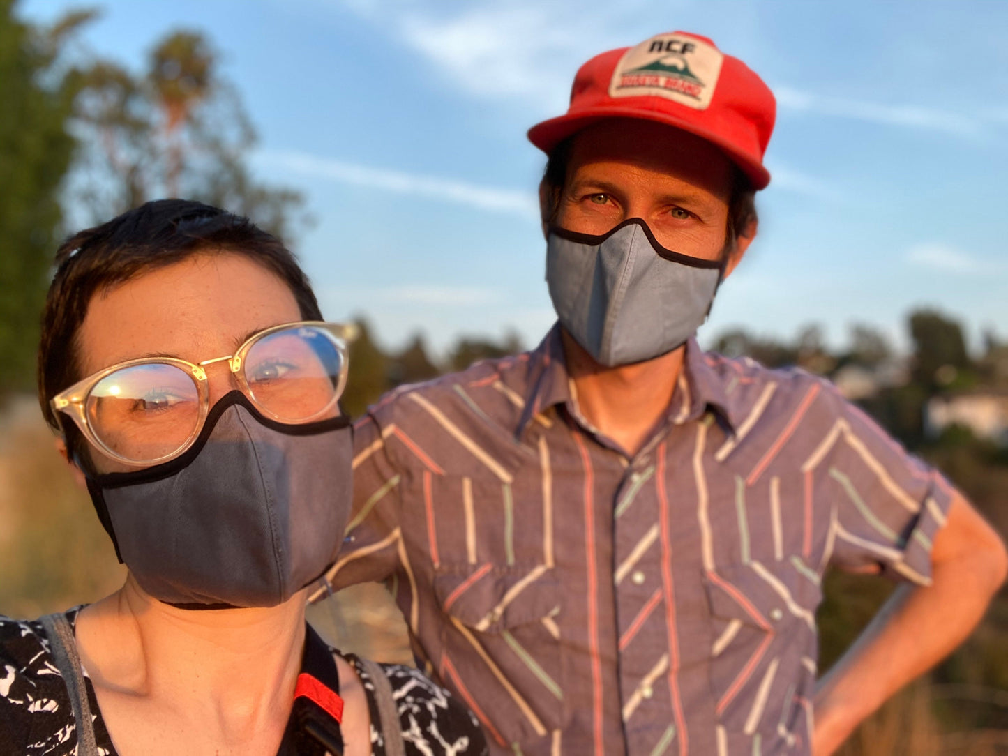 roxy wearing the organic summer cotton mask in cool river mick wearing the robin's egg blue